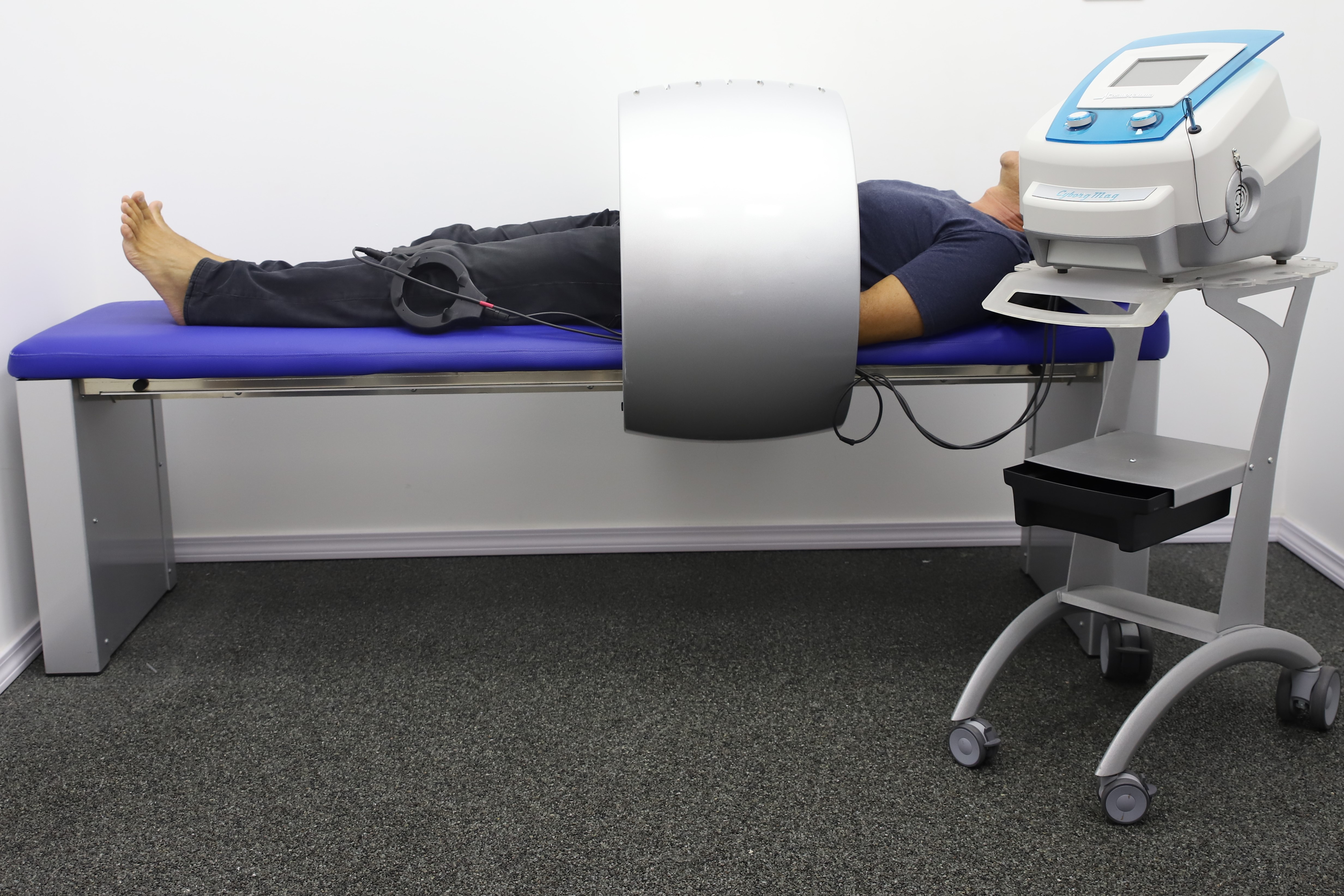Patient undergoing PEMF treatment in clinical setting